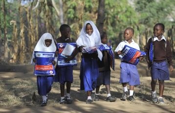 Children walk home after receiving bed nets at Iringo B primary school.